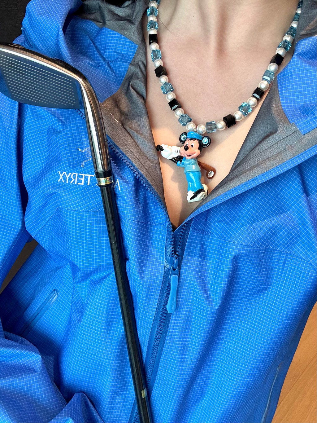 Vintage charm pendant close-up on handmade blue Swarovski crystal and pearl necklace