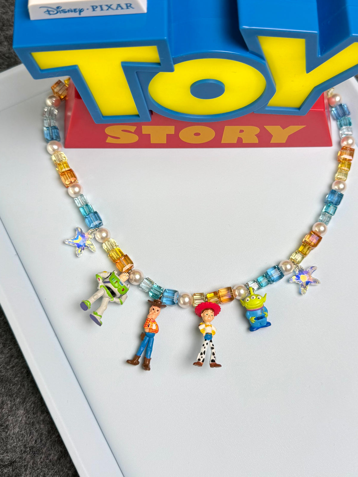 Model wearing handmade Swarovski crystal charm necklace with four vintage pendants - full body view