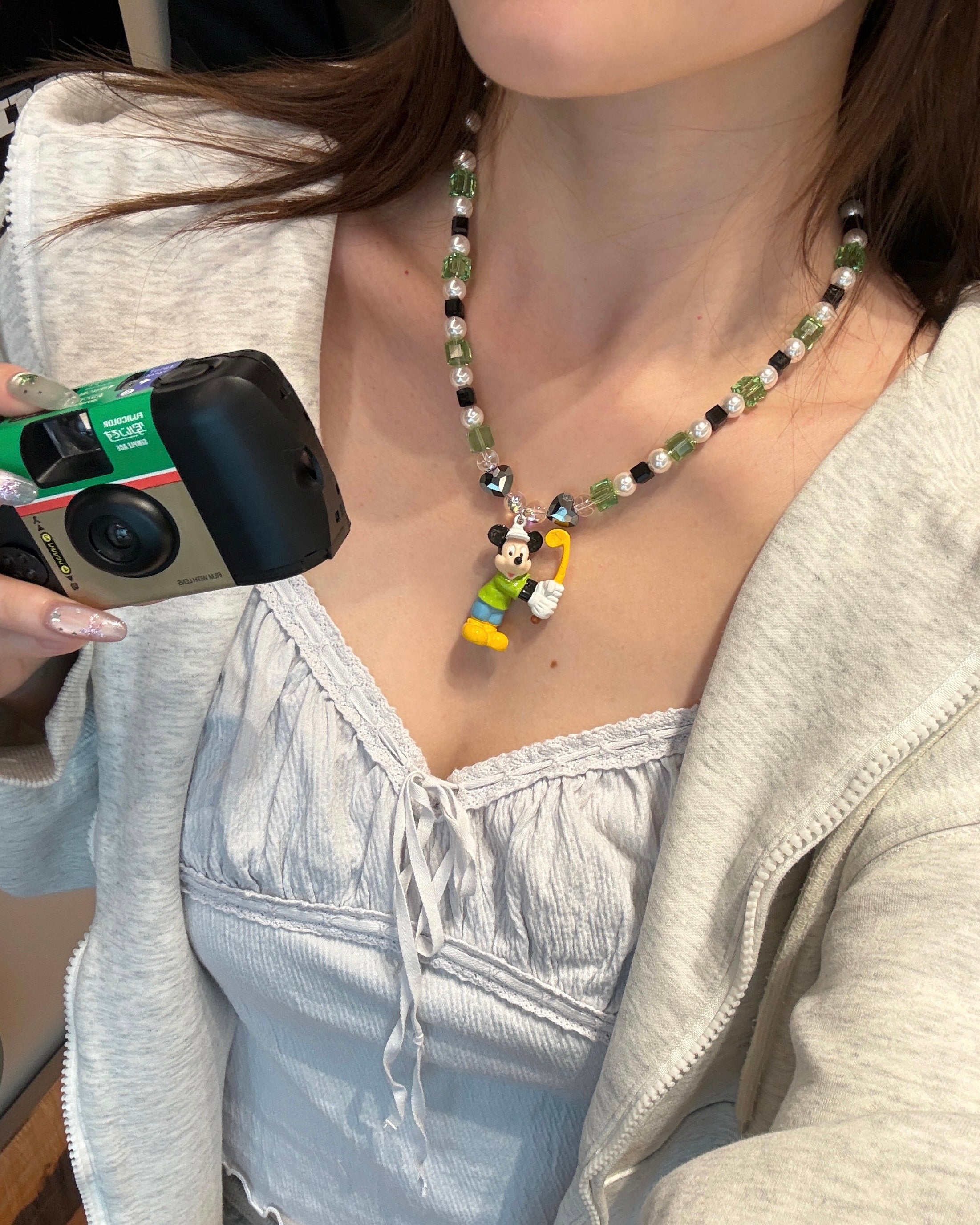 Close-up product image of Emerald Quest Crystal Charm Necklace featuring green cubes, black accents and mouse golfer charm.