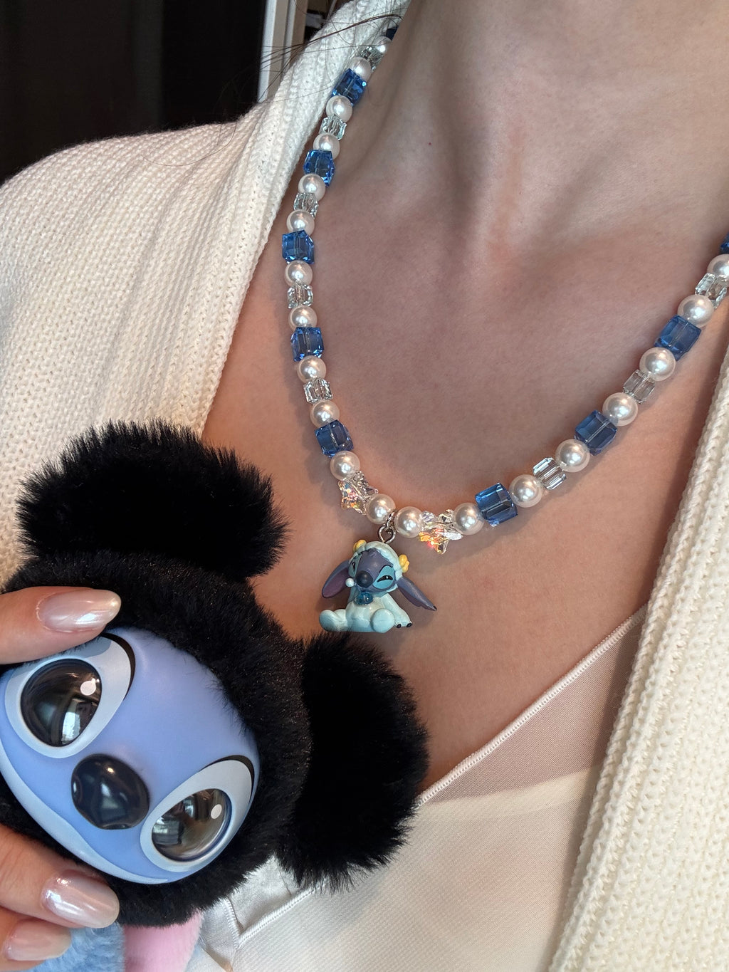 Vintage charm pendant close-up on handmade blue Swarovski crystal and pearl necklace - unique gift for her