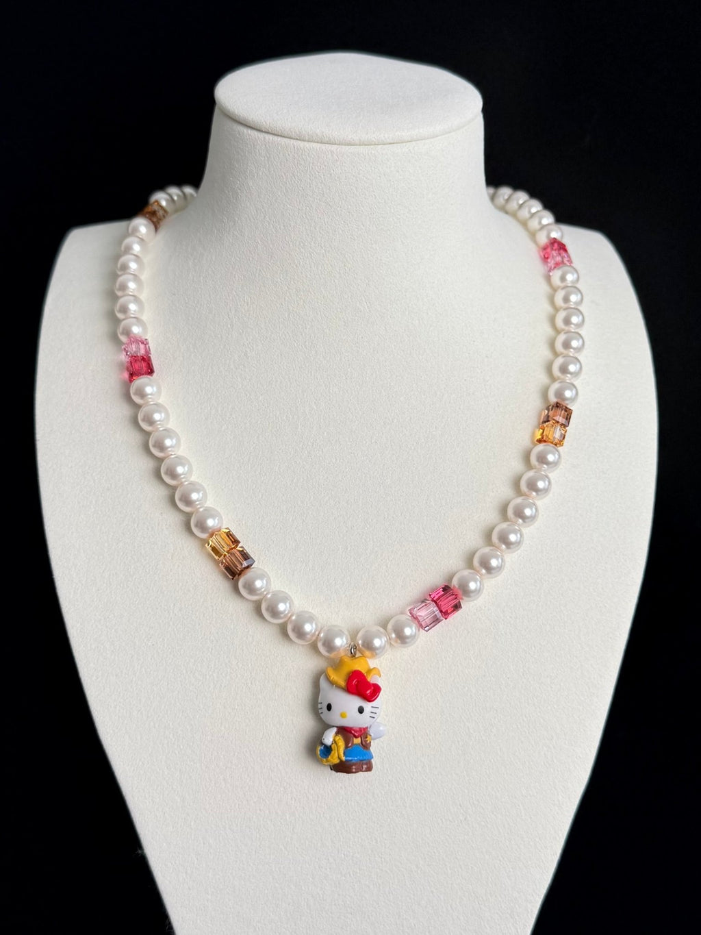 Model wearing handmade pink crystal charm necklace with amber Swarovski beads and pearls