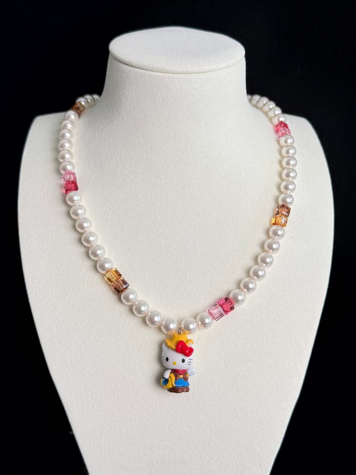 Model wearing handmade pink crystal charm necklace with amber Swarovski beads and pearls
