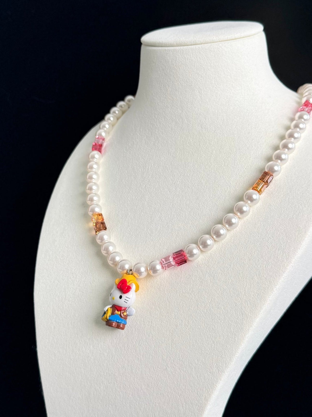 Pink and amber Swarovski crystal beads close-up on handmade charm necklace by ShinoraStudio