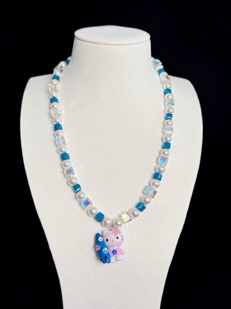 Model wearing handmade teal crystal charm necklace with Swarovski beads and pearls