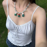 Model wearing a handmade colorful Swarovski crystal charm necklace with pearls and vintage-inspired charm details.