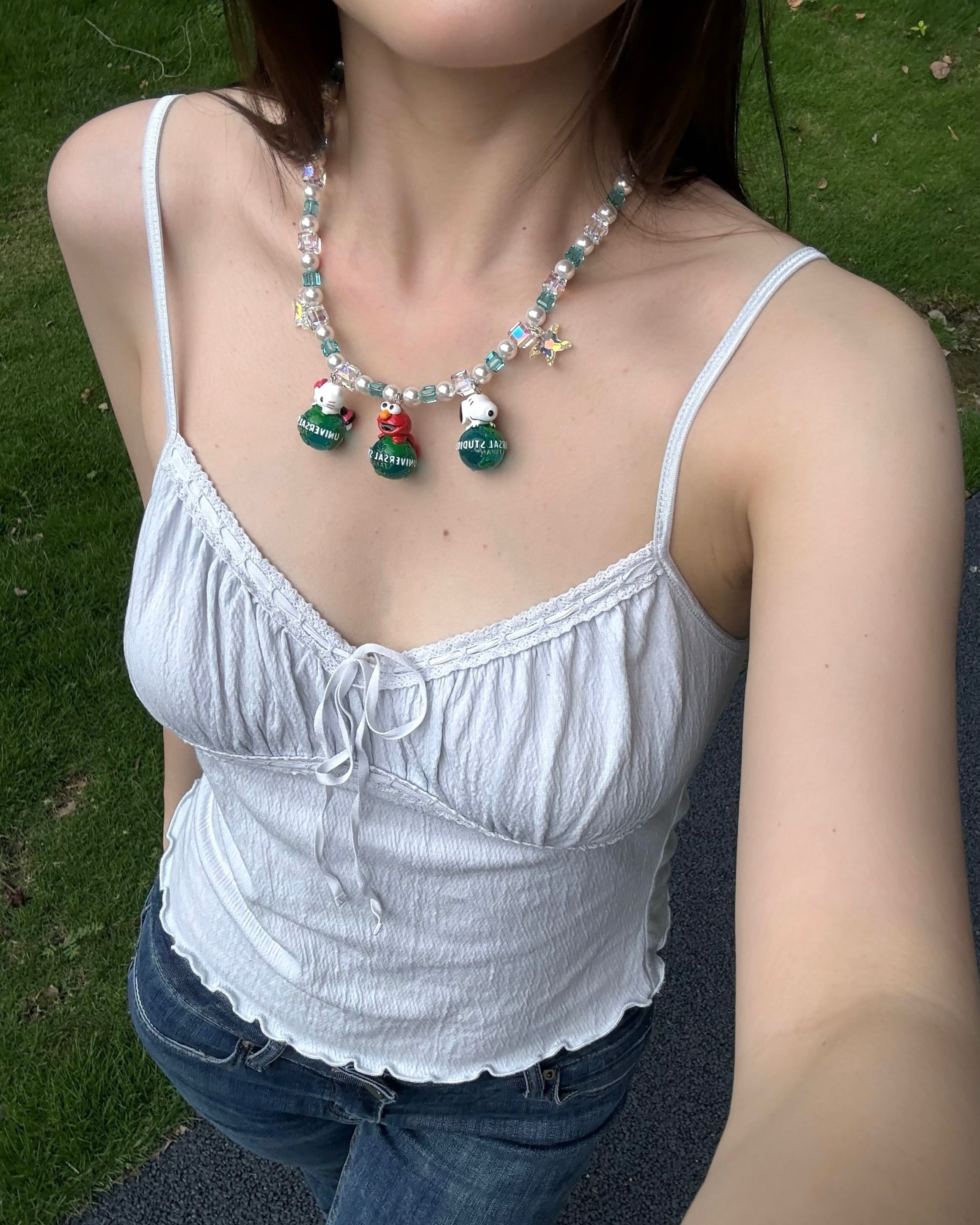 Model wearing a handmade colorful Swarovski crystal charm necklace with pearls and vintage-inspired charm details.