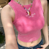 Model wearing a handmade rainbow Swarovski crystal charm necklace with pearls and vintage-inspired charm details.