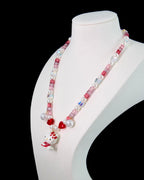 Model wearing handmade pink crystal charm necklace with ruby Swarovski beads and pearls