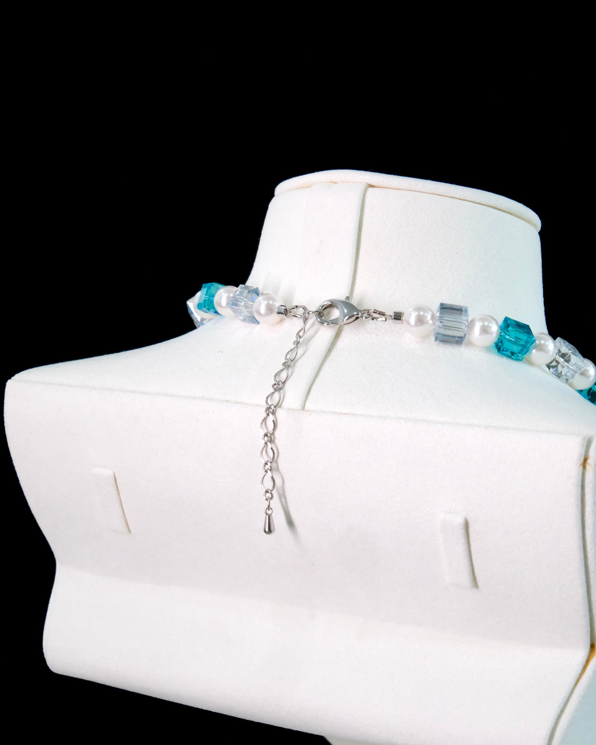 Blue Swarovski crystal beads close-up on handmade pearl charm necklace - unique beaded jewelry