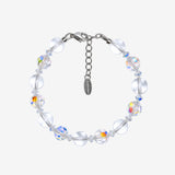 Bracelet with alternating smooth clear Swarovski beads and faceted iridescent crystals, clear spacers and a silver-tone clasp.