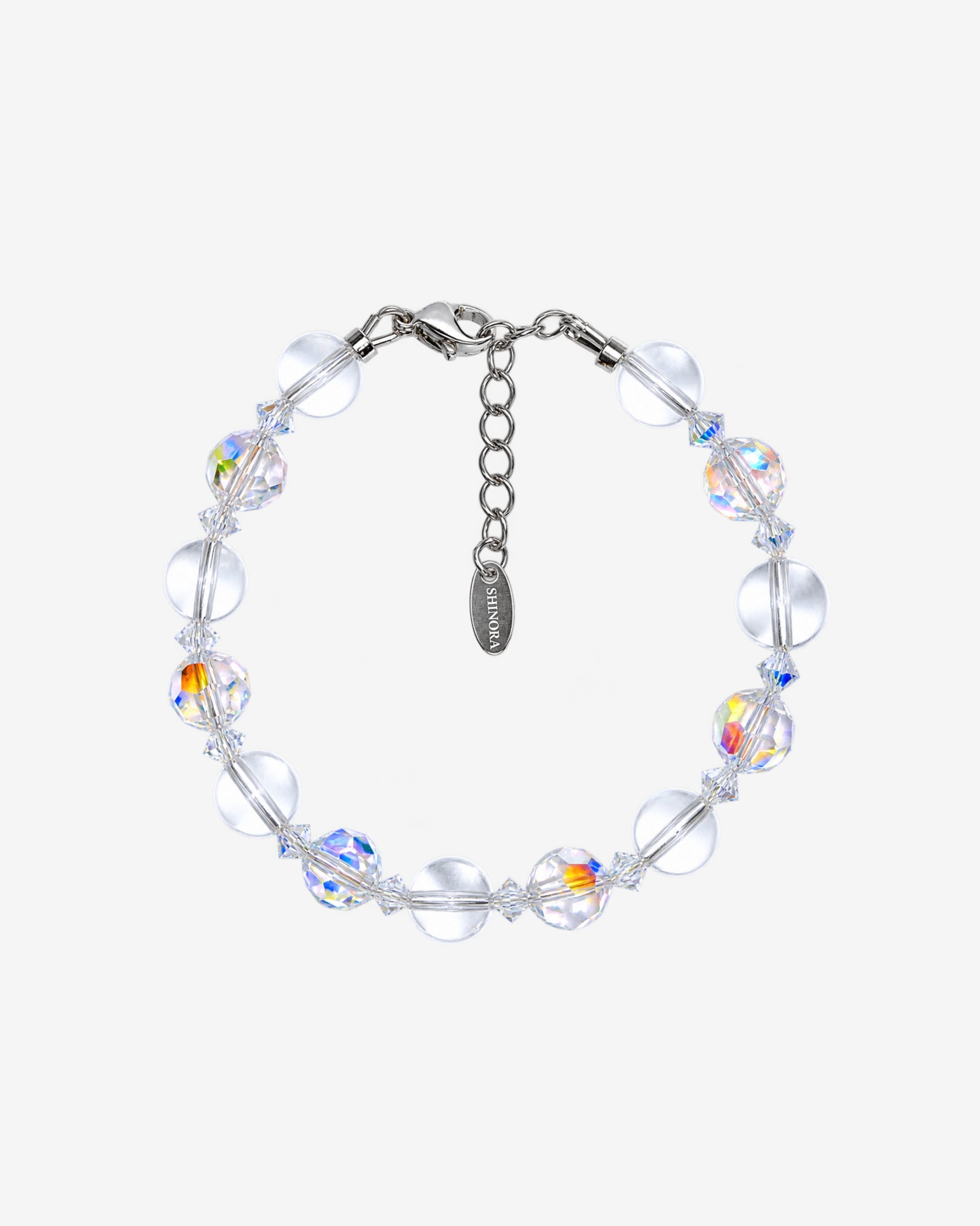 Bracelet with alternating smooth clear Swarovski beads and faceted iridescent crystals, clear spacers and a silver-tone clasp.