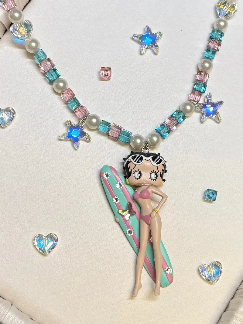 Close-up of Swarovski crystal and pearl beads on Betty Boop handmade vintage charm necklace

