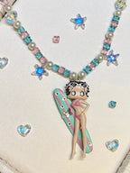 Close-up of Swarovski crystal and pearl beads on Betty Boop handmade vintage charm necklace

