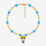 Necklace with blue and yellow Swarovski crystals, white crystal pearls and a blonde girl charm with pigtails and a blue dress.