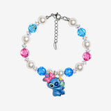 Bright blue and pink Swarovski crystals alternate with white crystal pearls and clear crystal spacers. At the center, bow-wearing Stitch holds Scrump.