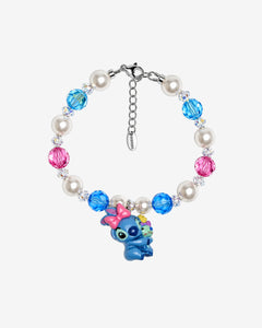 Bright blue and pink Swarovski crystals alternate with white crystal pearls and clear crystal spacers. At the center, bow-wearing Stitch holds Scrump.