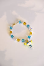 Close-up of vintage Bubbles Powerpuff Girls charm on handmade Swarovski crystal and pearl bracelet