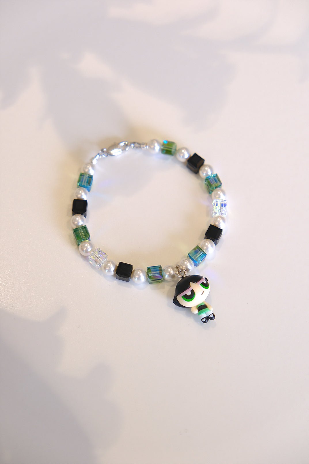  Close-up of vintage Buttercup Powerpuff Girls charm on handmade Swarovski crystal and pearl bracelet
