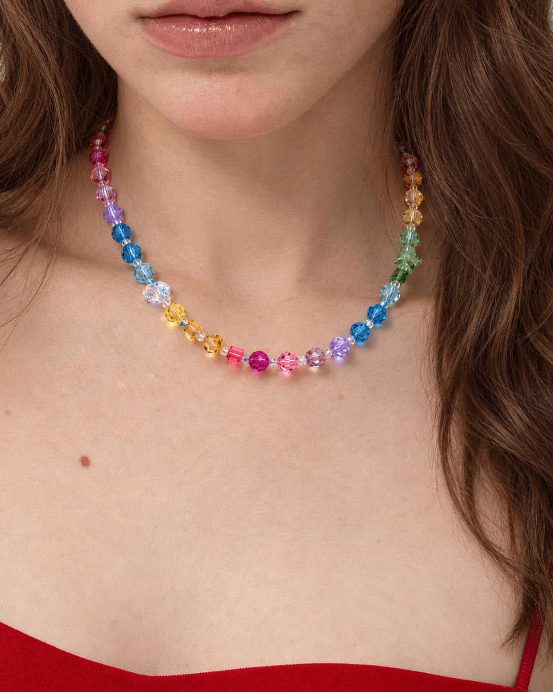 Rainbow Prism Crystal Choker with multicolored faceted beads, worn around the neck above a red top.