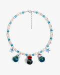 Handmade vintage charm Swarovski necklace with sky-blue crystals, iridescent AB beads and white pearls - flat lay