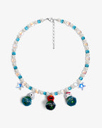 Handmade vintage charm Swarovski necklace with sky-blue crystals, iridescent AB beads and white pearls - flat lay