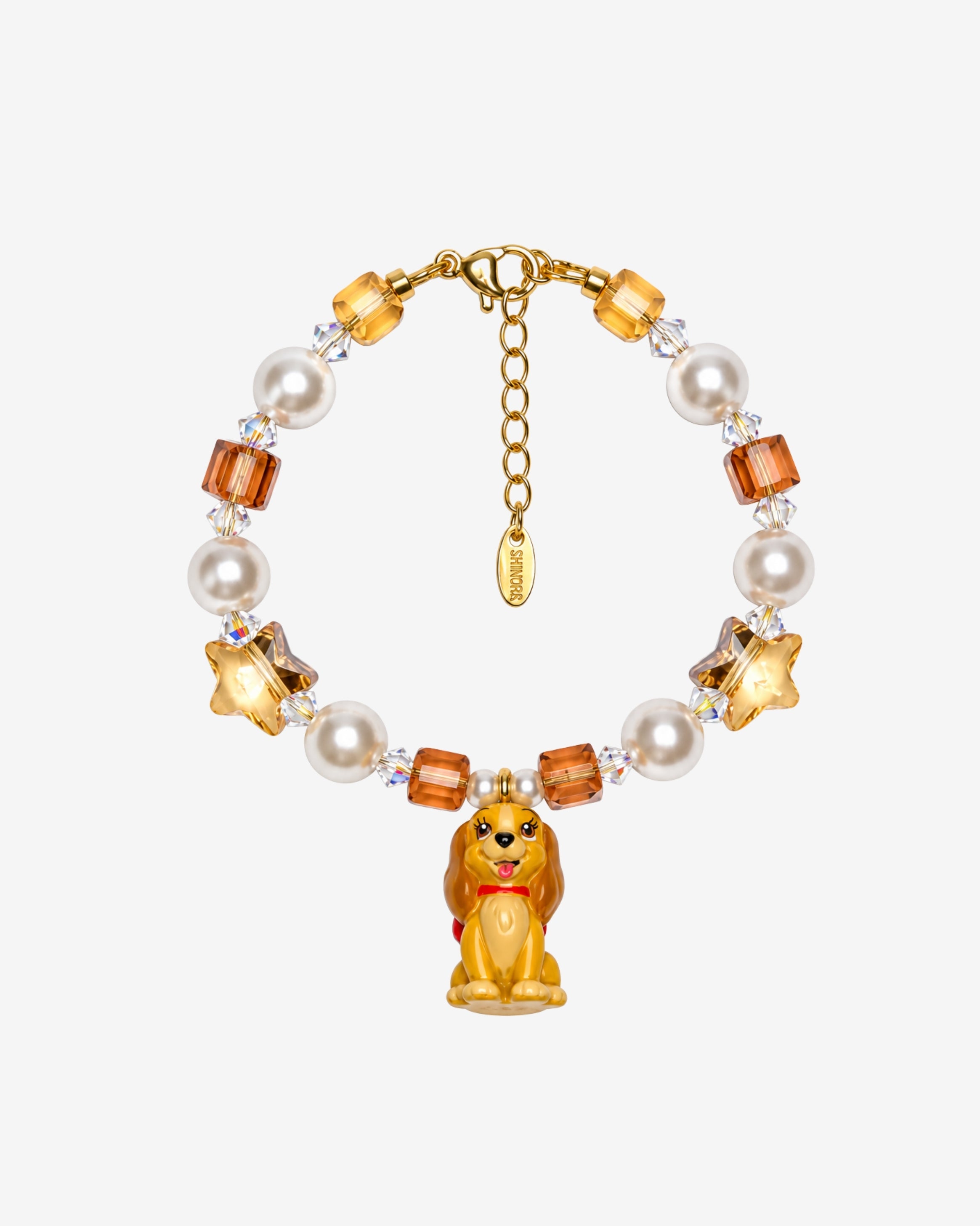 Golden Star Pup Charm Bracelet with amber faceted beads, cream pearl-style beads, gold stars and a brown dog charm.
