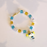 Close-up of a handmade blue Swarovski crystal charm bracelet with crystals, pearls and nostalgic vintage-inspired collectible charm details