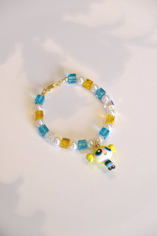 Close-up of a handmade blue Swarovski crystal charm bracelet with crystals, pearls and nostalgic vintage-inspired collectible charm details