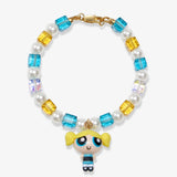 Flat lay of a handmade blue Swarovski crystal charm bracelet with crystals, pearls and nostalgic vintage-inspired collectible charm details