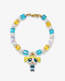 Flat lay of a handmade blue Swarovski crystal charm bracelet with crystals, pearls and nostalgic vintage-inspired collectible charm details