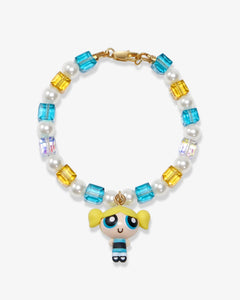 Flat lay of a handmade blue Swarovski crystal charm bracelet with crystals, pearls and nostalgic vintage-inspired collectible charm details