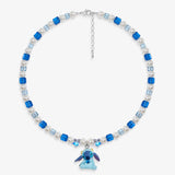 Close-up of a handmade blue Swarovski crystal charm necklace with crystals, pearls and cosmic-inspired collectible charm details