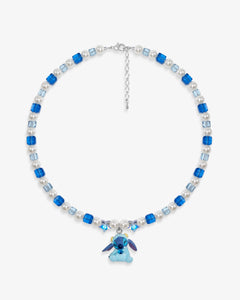 Close-up of a handmade blue Swarovski crystal charm necklace with crystals, pearls and cosmic-inspired collectible charm details