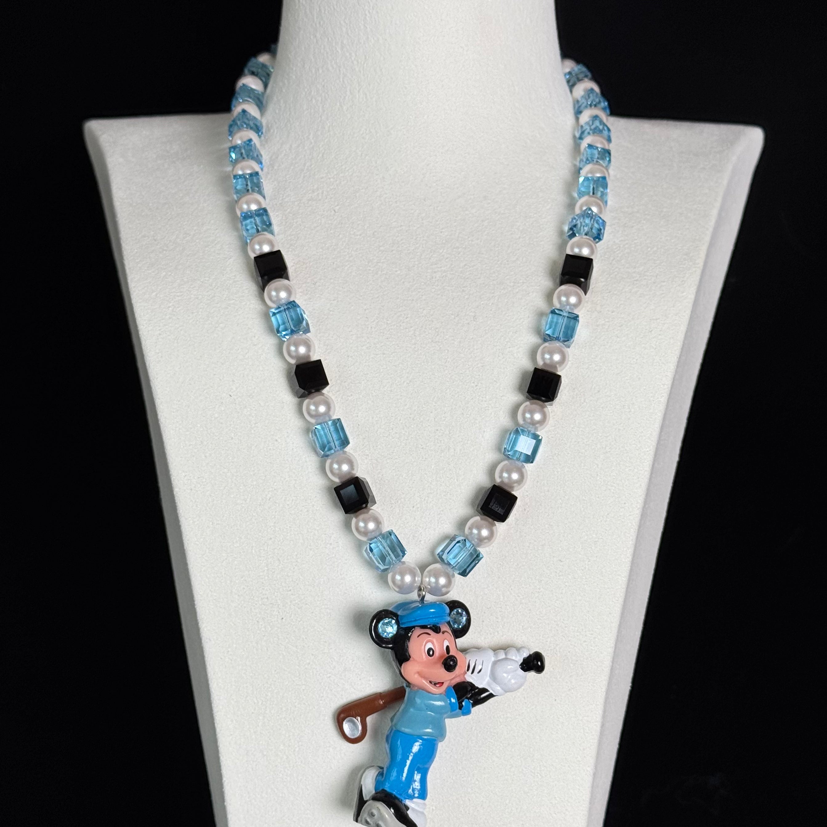 Display view of a handmade blue Swarovski crystal charm necklace with crystals, pearls and sport-inspired collectible charm details