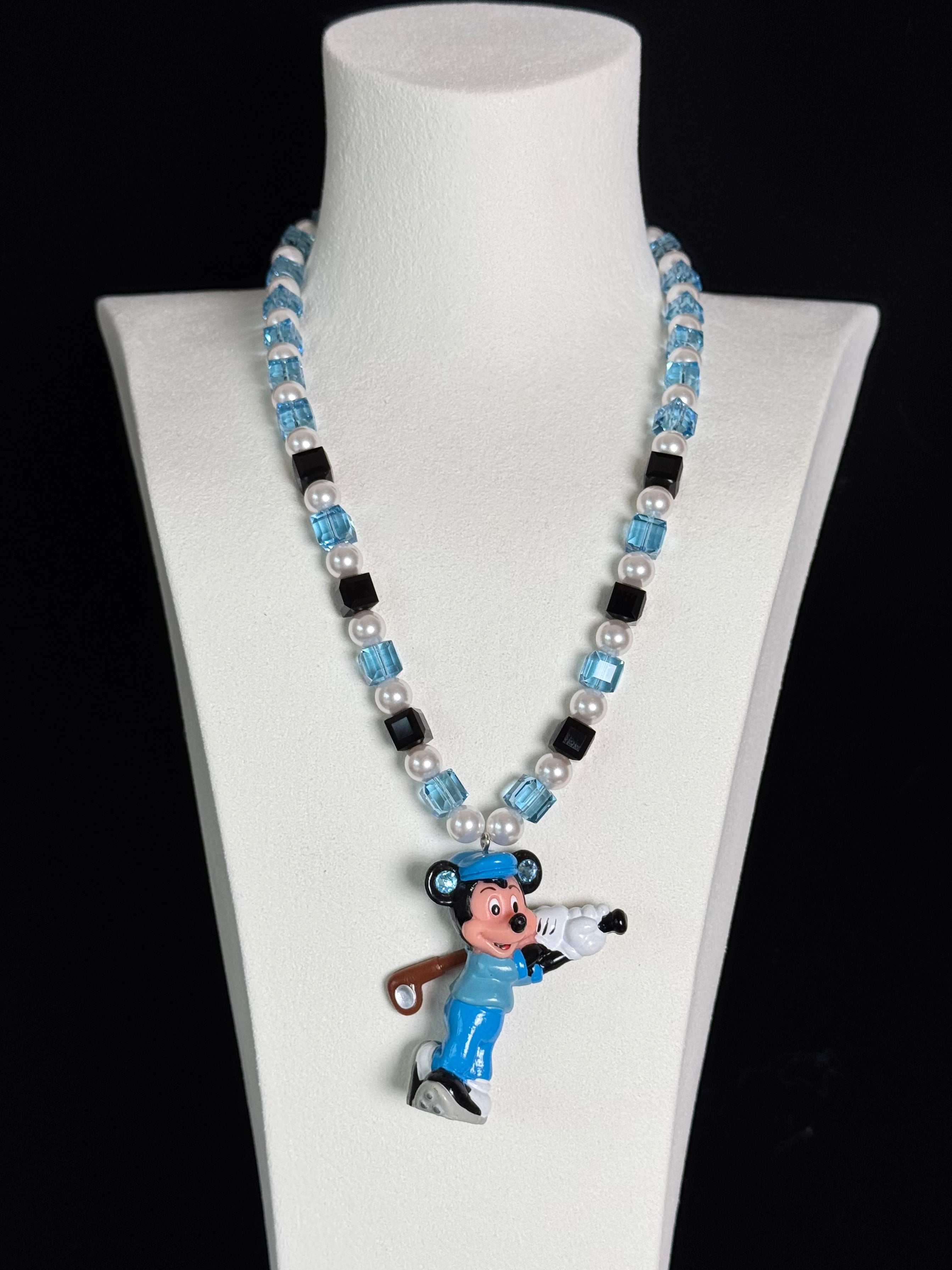 Display view of a handmade blue Swarovski crystal charm necklace with crystals, pearls and sport-inspired collectible charm details
