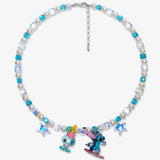 Flat lay of a handmade blue Swarovski crystal charm necklace with crystals, pearls and surf-inspired collectible charm details