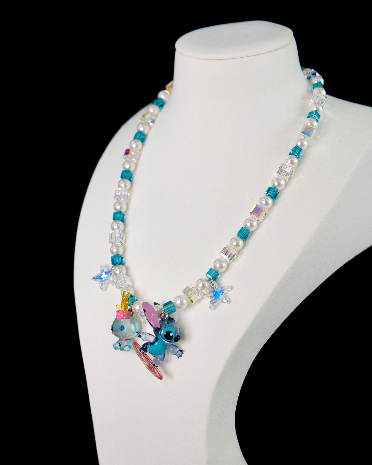 Model wearing a handmade blue Swarovski crystal charm necklace with crystals, pearls and surf-inspired collectible charm details