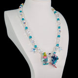 Side view of a handmade blue Swarovski crystal charm necklace with layered crystals, pearls and surf-inspired collectible charm details