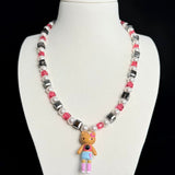 Model wearing a handmade dark Swarovski crystal charm necklace with crystals, pearls and city-inspired collectible charm details