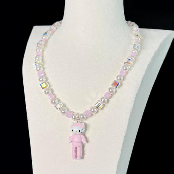 Close-up of a handmade iridescent Swarovski crystal charm necklace with crystals, pearls and sport-inspired collectible charm details