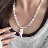 Close-up of a handmade iridescent Swarovski crystal charm necklace with crystals, pearls and sport-inspired collectible charm details
