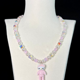 Close-up of a handmade iridescent Swarovski crystal charm necklace with crystals, pearls and sport-inspired collectible charm details