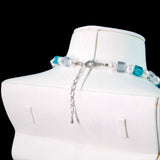 Close-up of a handmade midnight Swarovski crystal charm necklace with crystals, pearls and princess-inspired collectible charm details