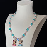 Close-up of a handmade pastel Swarovski crystal charm necklace with crystals, pearls and nostalgic vintage-inspired collectible charm details