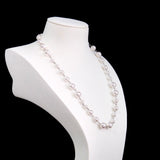 Close-up of a handmade Swarovski crystal and pearl necklace with crystals, pearls and clean pearl styling details
