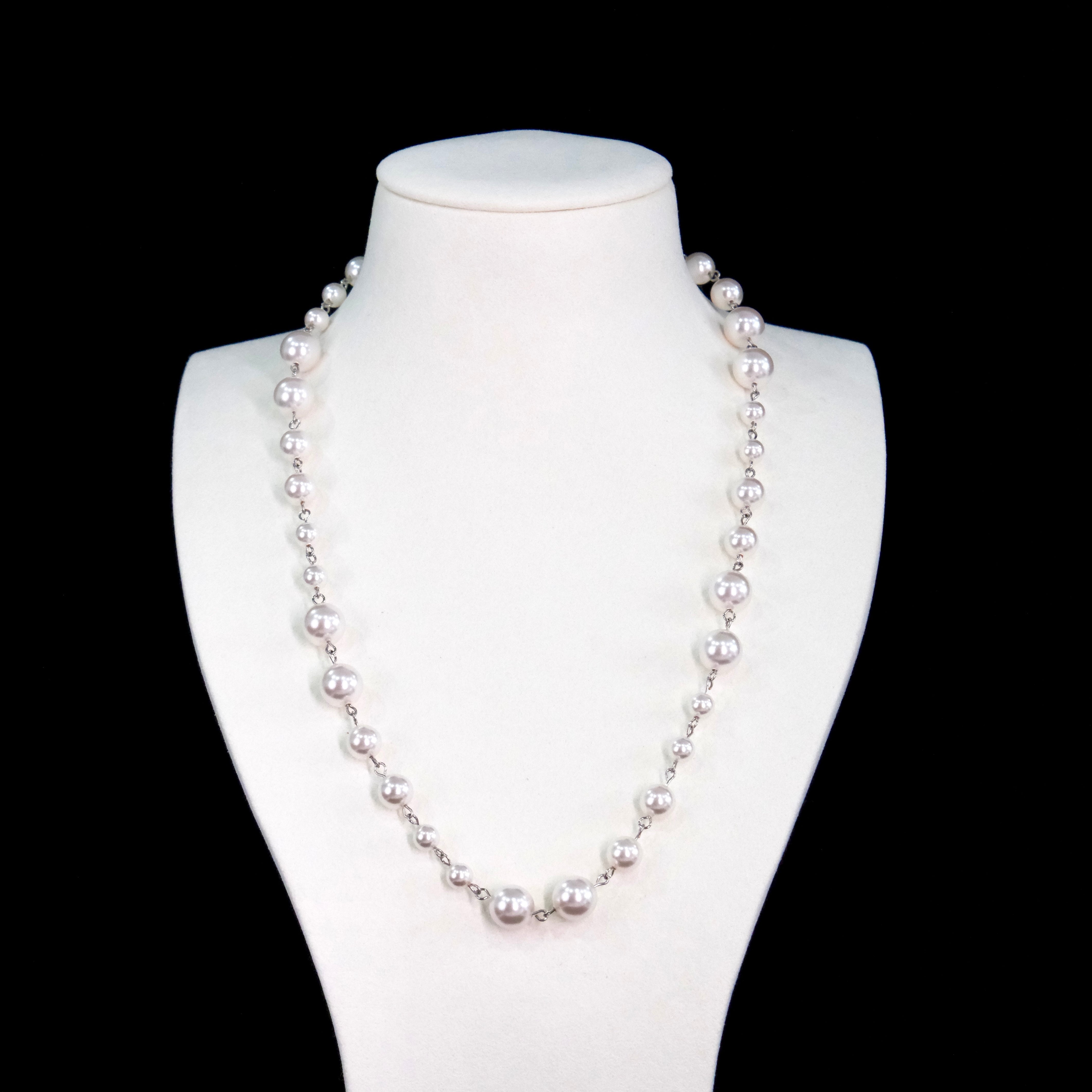 Close-up of a handmade Swarovski crystal and pearl necklace with crystals, pearls and clean pearl styling details
