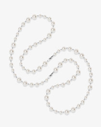 Flat lay of a handmade Swarovski crystal and pearl necklace with crystals, pearls and clean pearl styling details
