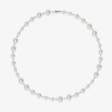 Flat lay of a handmade Swarovski crystal and pearl necklace with crystals, pearls and clean pearl styling details
