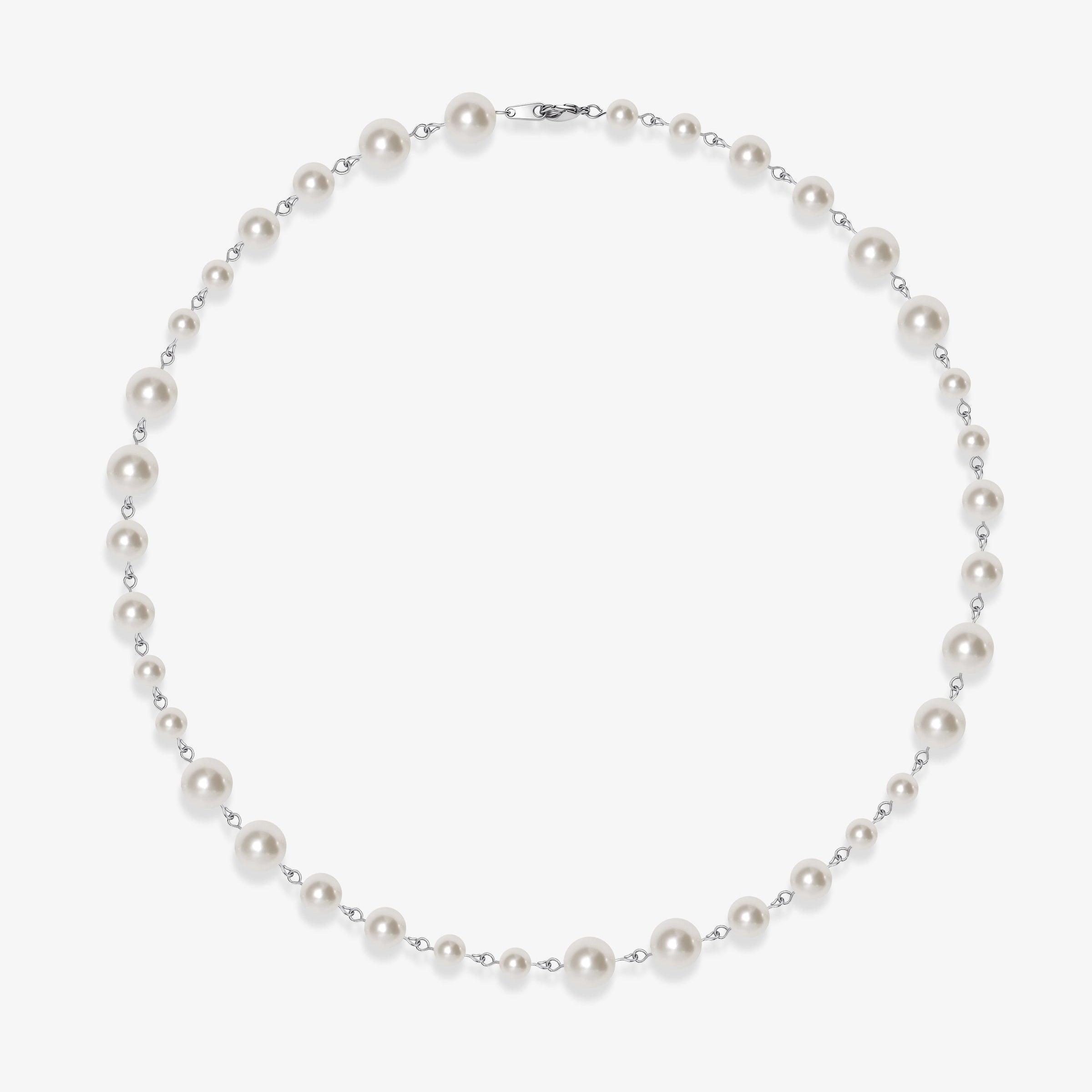 Flat lay of a handmade Swarovski crystal and pearl necklace with crystals, pearls and clean pearl styling details