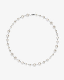 Flat lay of a handmade Swarovski crystal and pearl necklace with crystals, pearls and clean pearl styling details